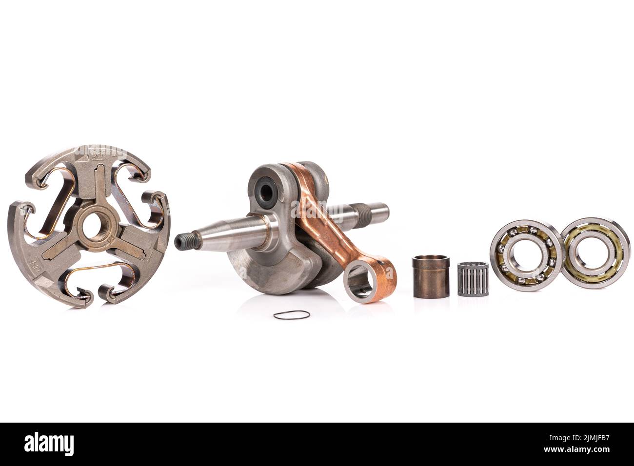 Crankshaft and other spare parts for garden machinery on a white