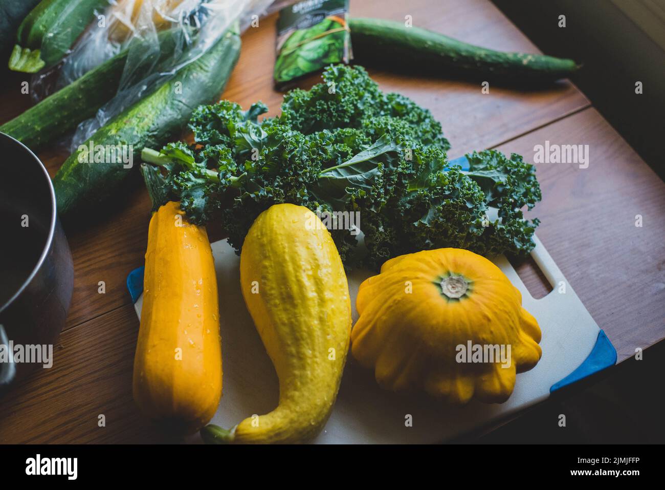 Squash and collard greens on a cutting board Stock Photo Alamy