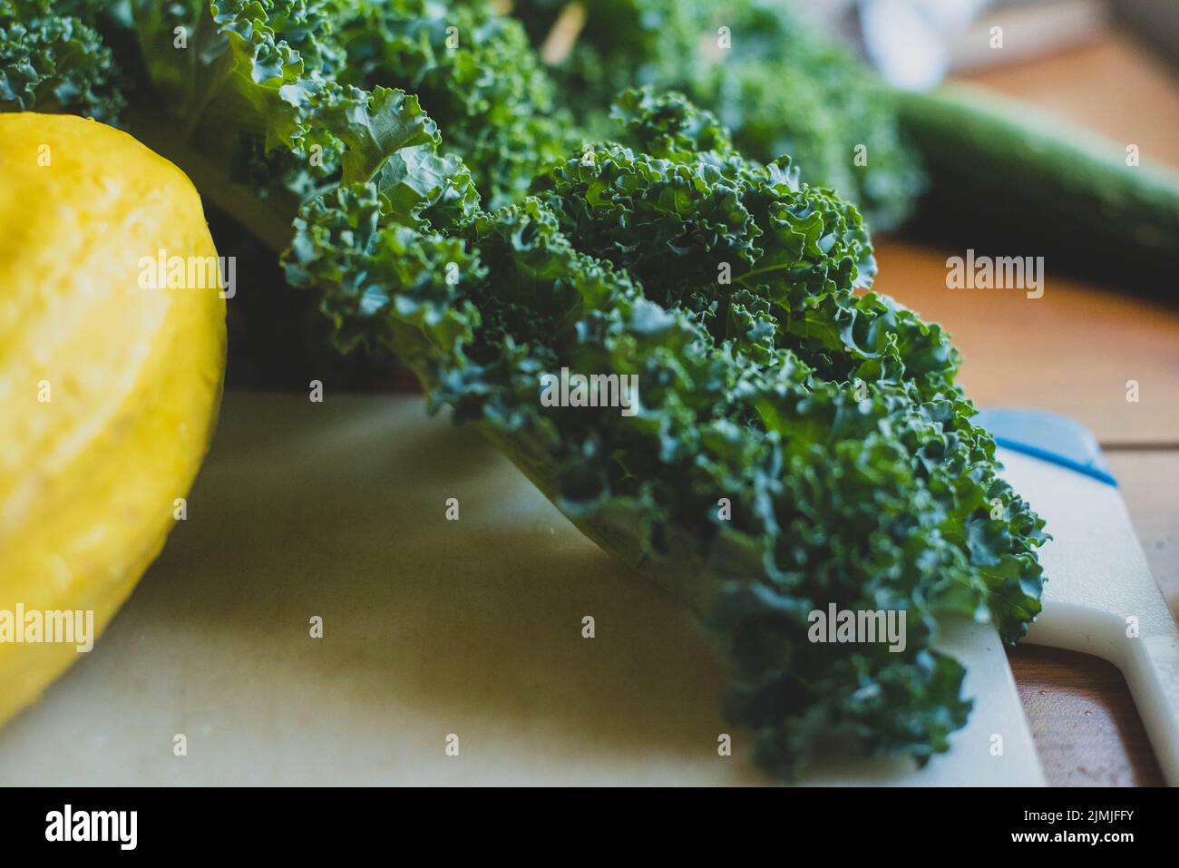 Squash and collard greens on a cutting board Stock Photo Alamy