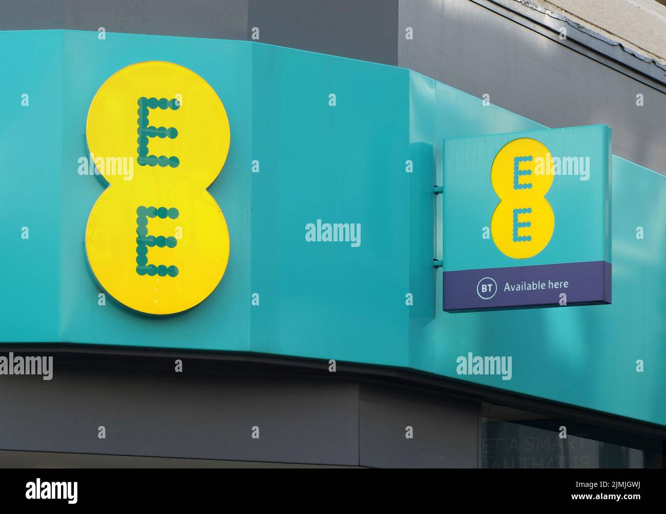 Sign and logo above the entrance to an EE mobile phone store in
