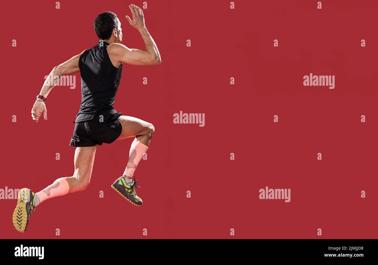 Low angle man running with copy space Stock Photo