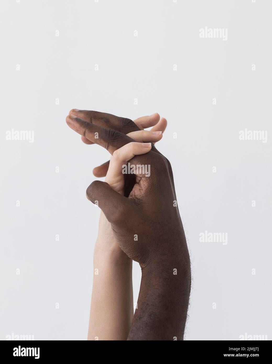 Black white hands holding sideways Stock Photo