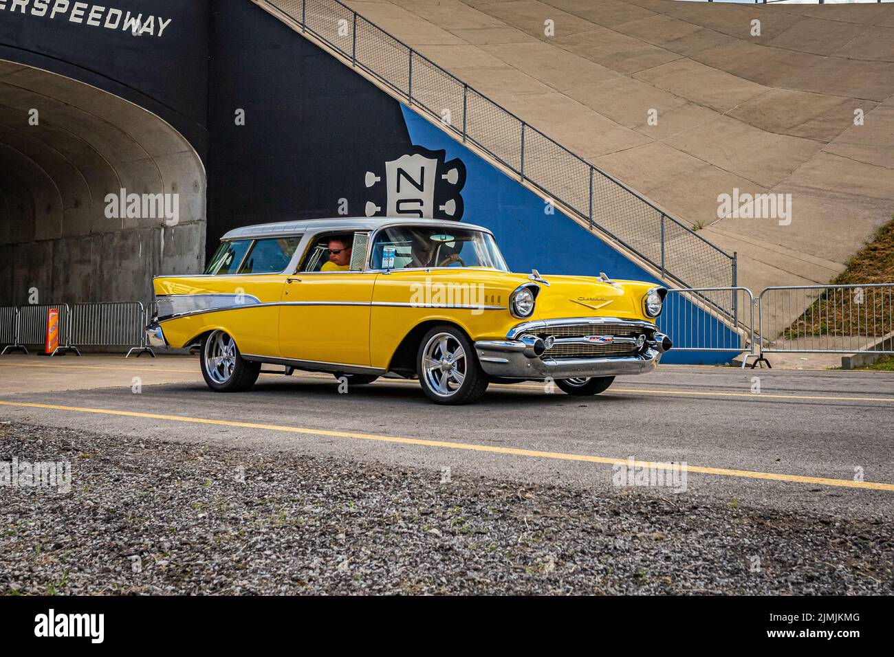 Lebanon, TN - May 14, 2022: Wide angle front corner view of a 1957 Chevrolet BelAir Nomad Wagon driving on a road leaving a local car show. Stock Photo