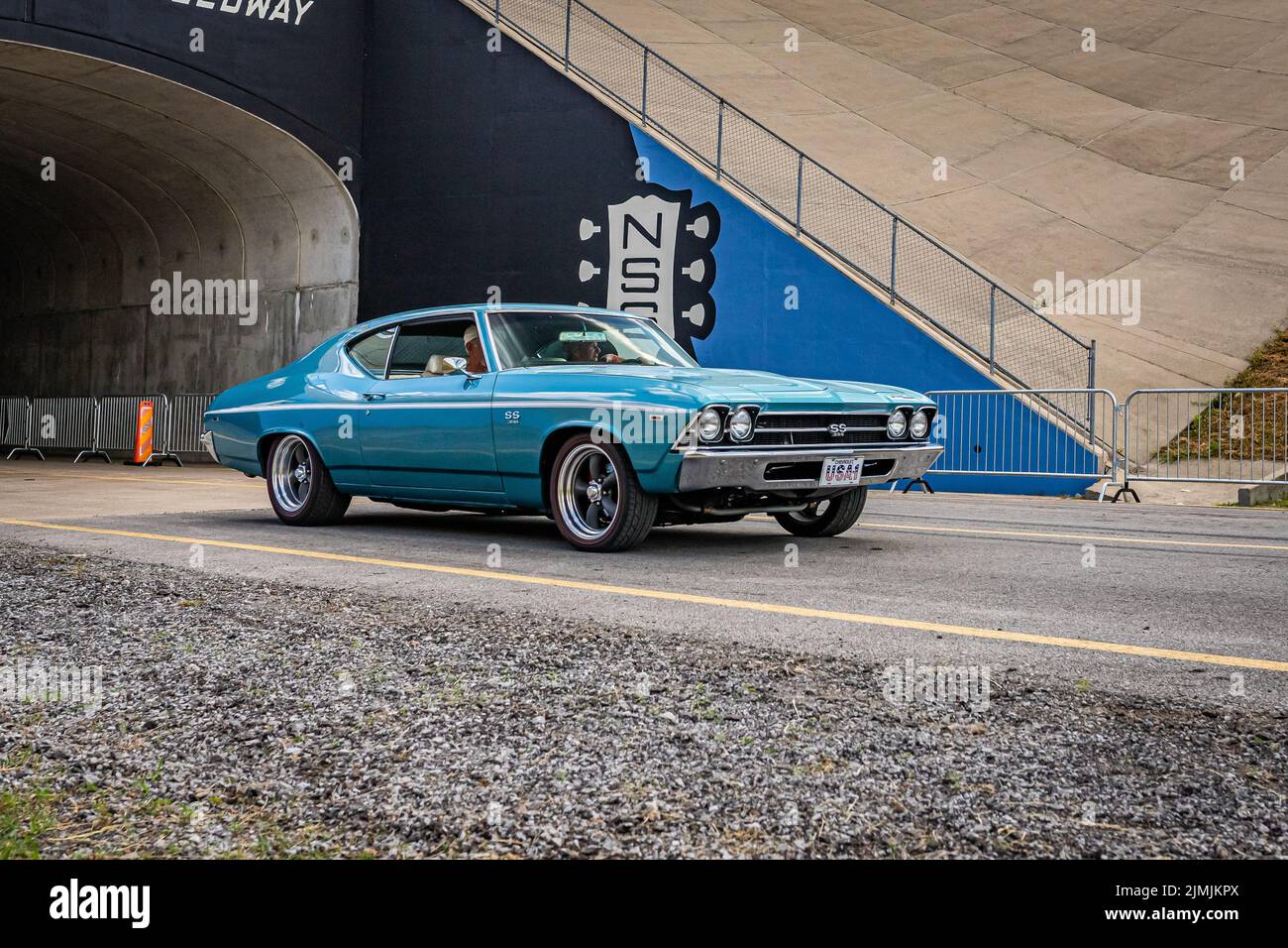 Lebanon, TN - May 14, 2022: Wide angle front corner view of a 1969 Chevrolet Chevelle SS 396 Coupe driving on a road leaving a local car show. Stock Photo