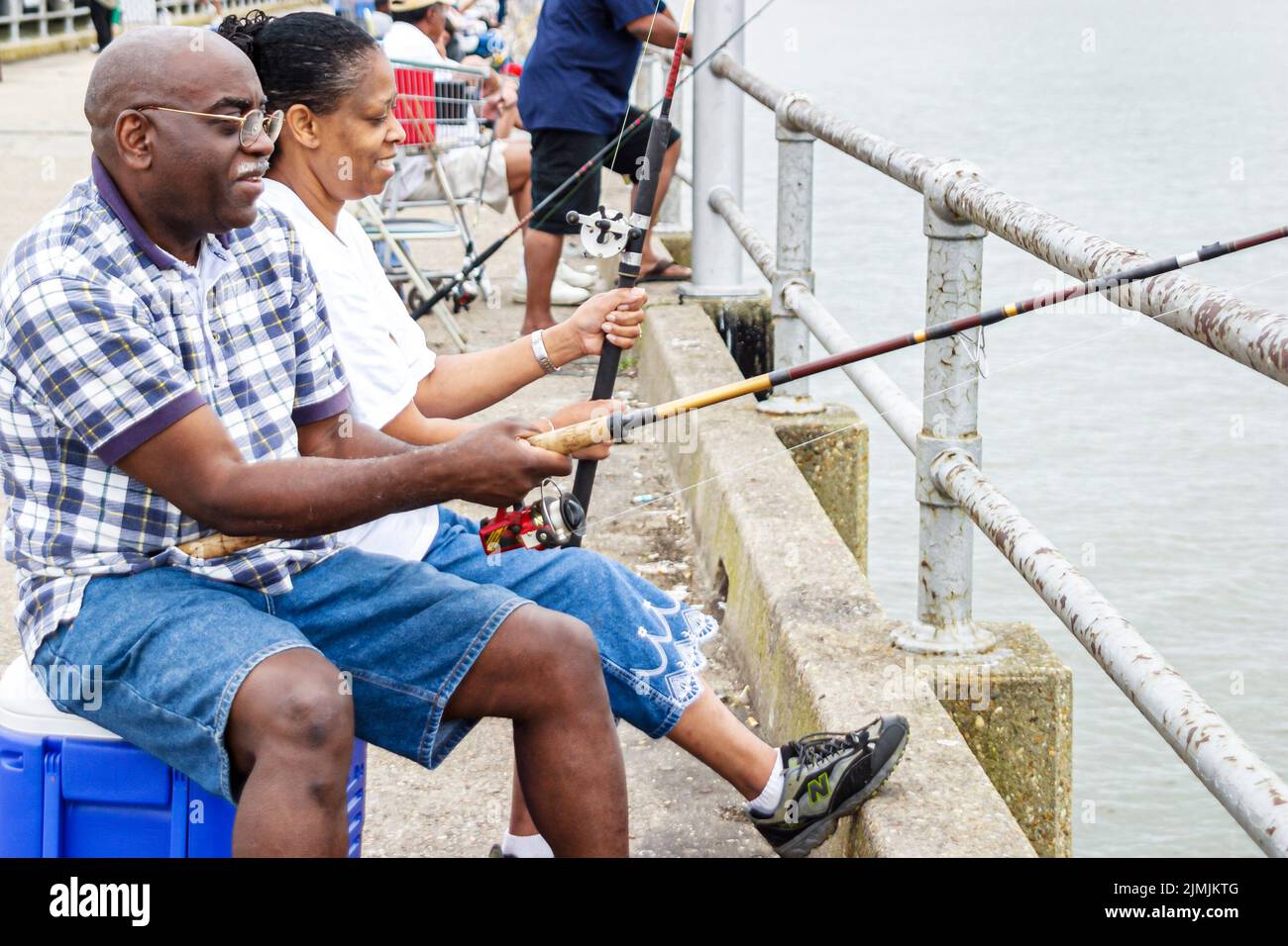 Virginia Newport News near James River Bridge,fishing recreation water dock pier couple Black man woman,visitors people person scene in a photo Stock Photo