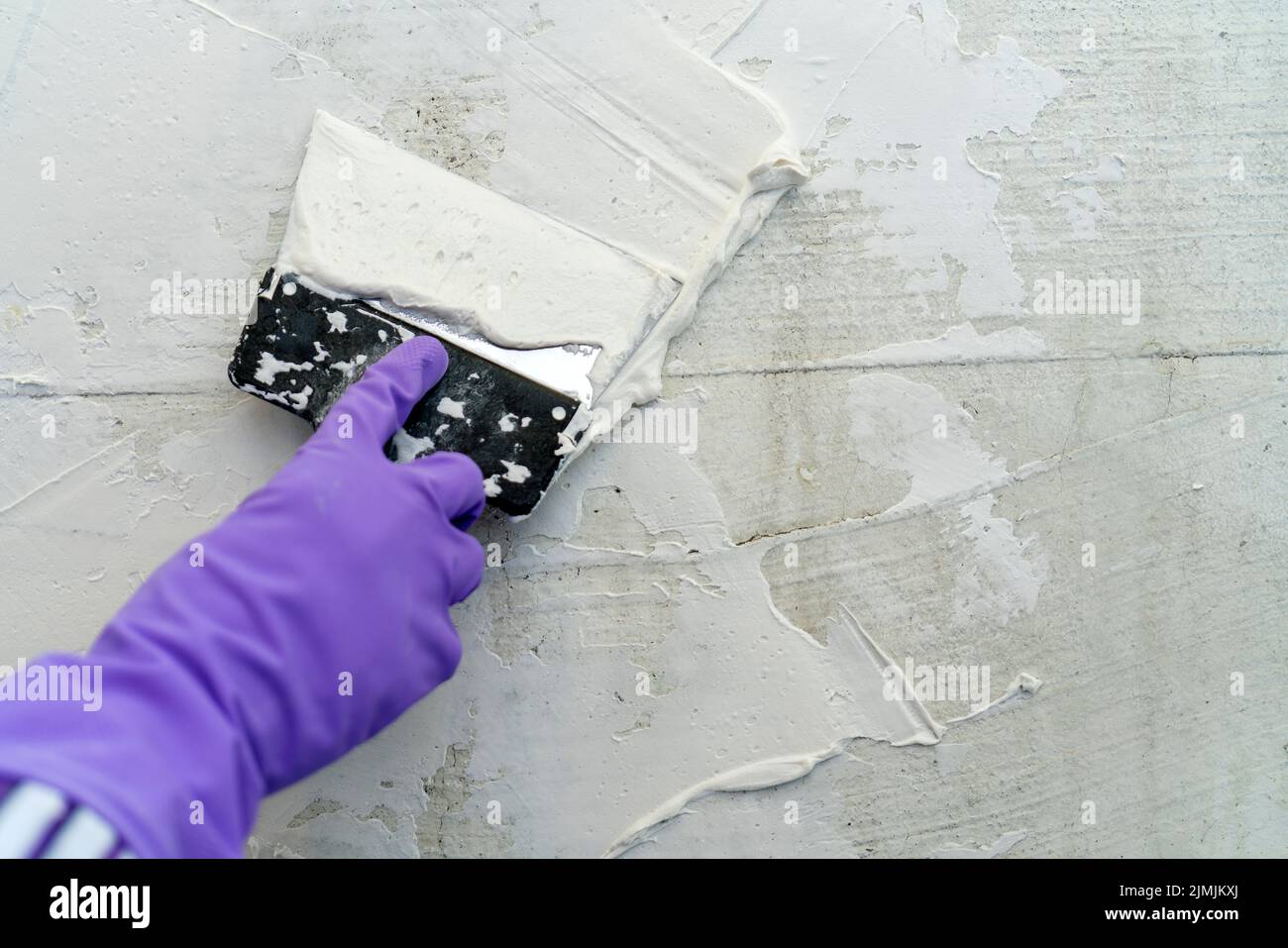 Texture of white plaster. Covering the concrete wall of the house