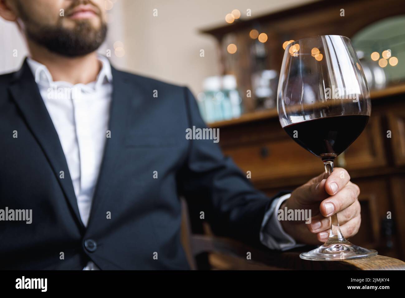 Man with a glass of red wine Stock Photo - Alamy
