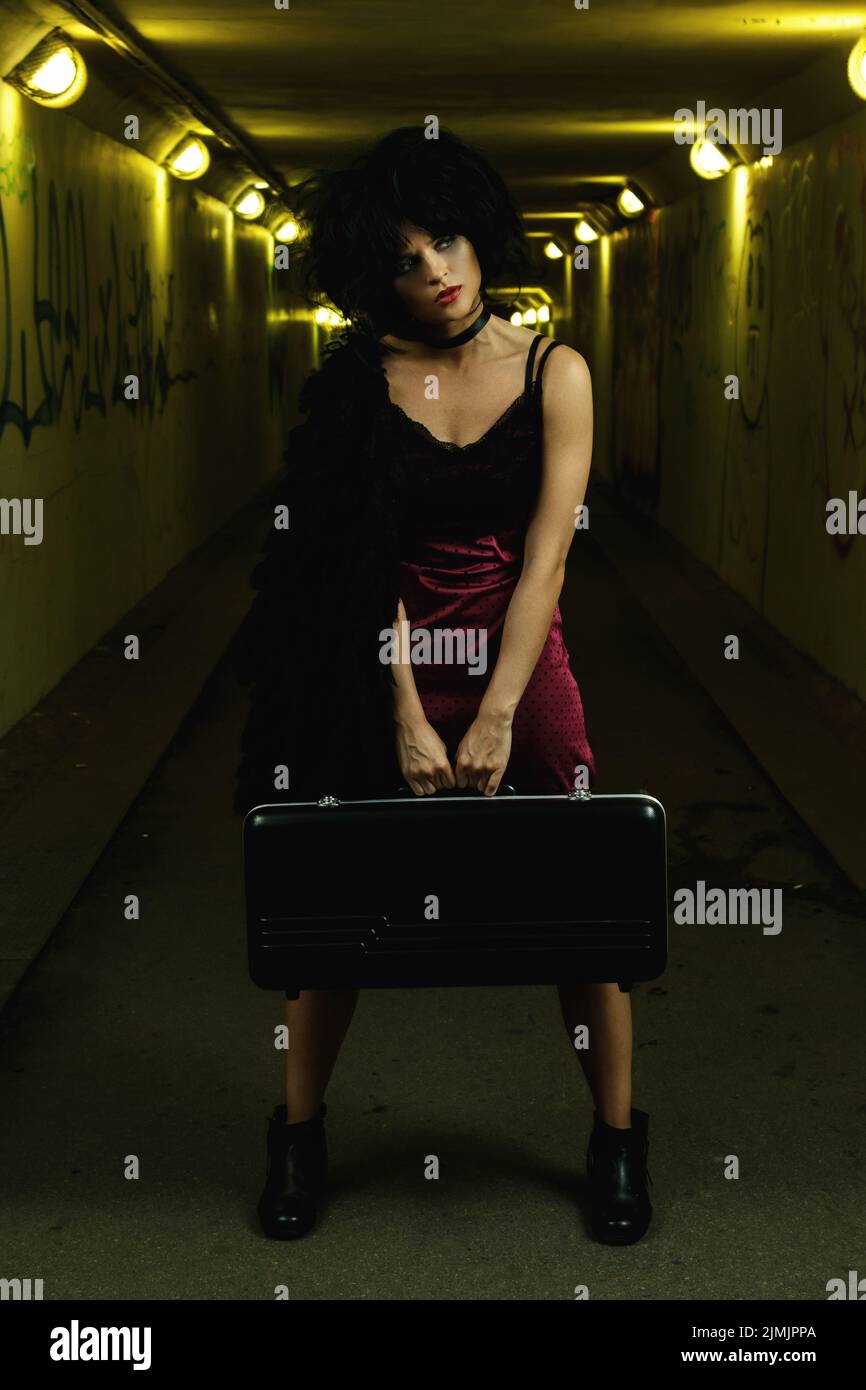 Strange and freaky woman in the dark tunnel Stock Photo
