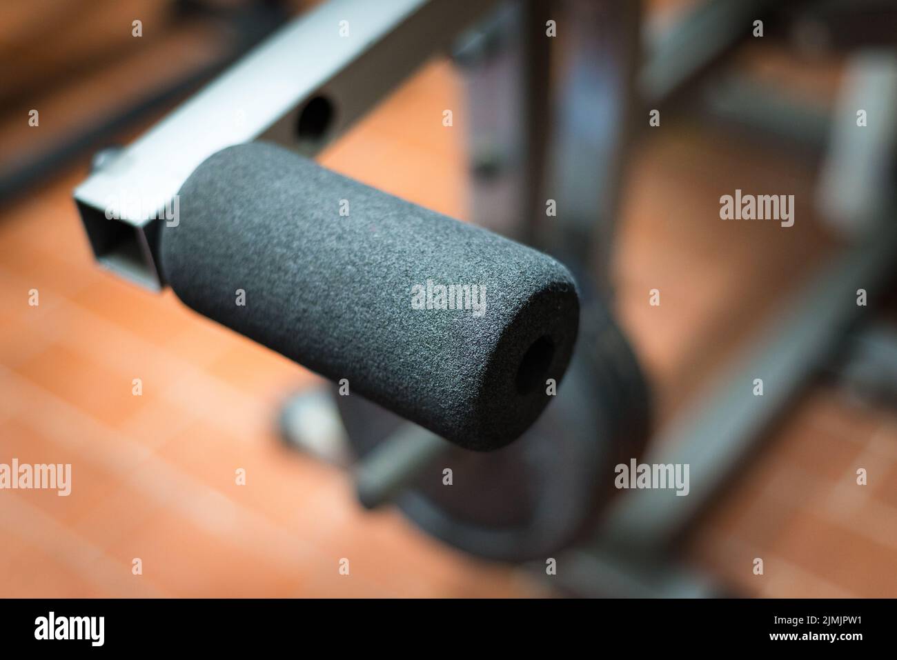 Black desk of free space for your decoration and blurred gym interior.Metal dumbbells and fit life Stock Photo