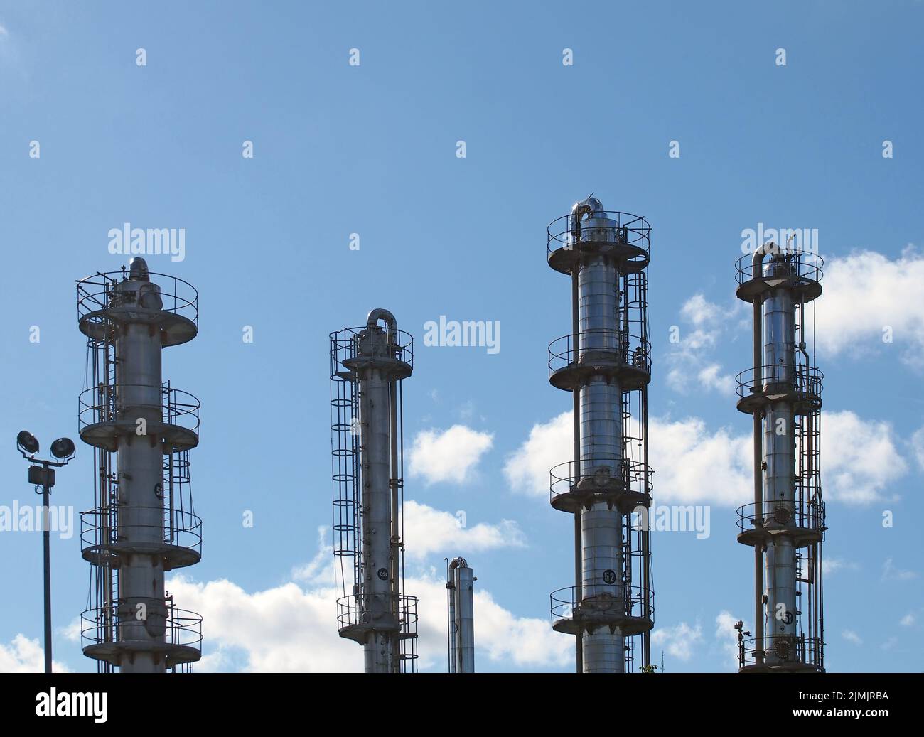 Tall steel fractionation or cooling towers at a large industrial chemical plant Stock Photo