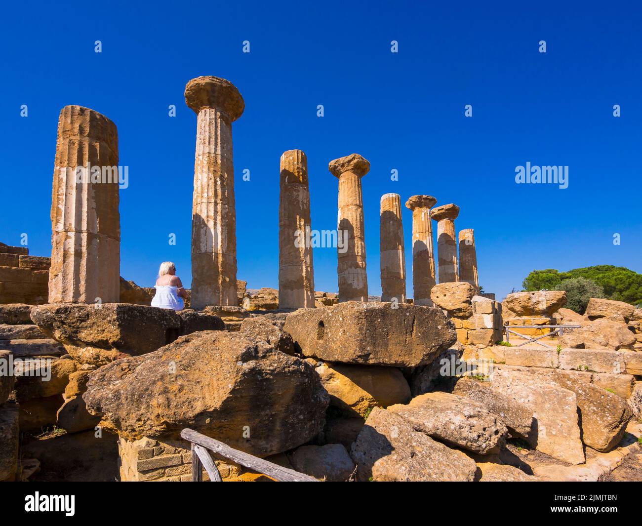 A woman with white dress looks at the temple Stock Photo