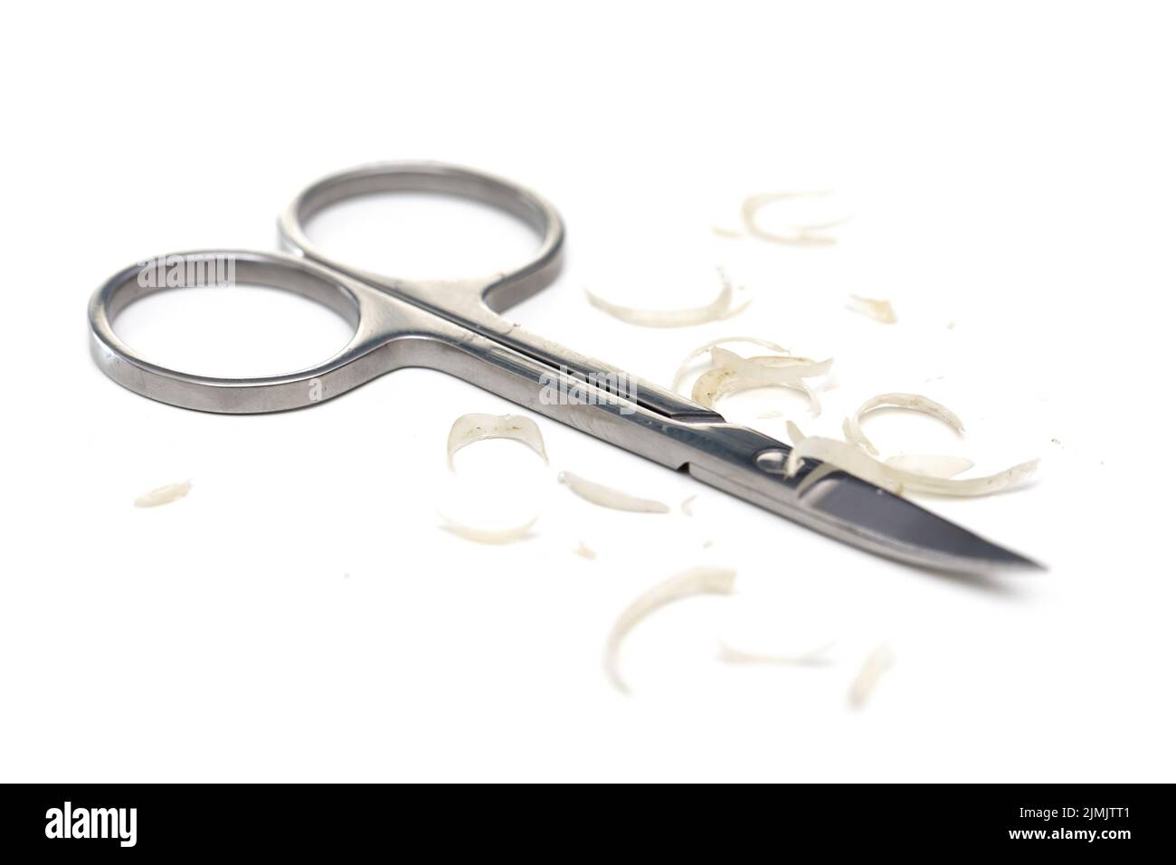 Manicure scissors and nail clipping on white background Stock Photo