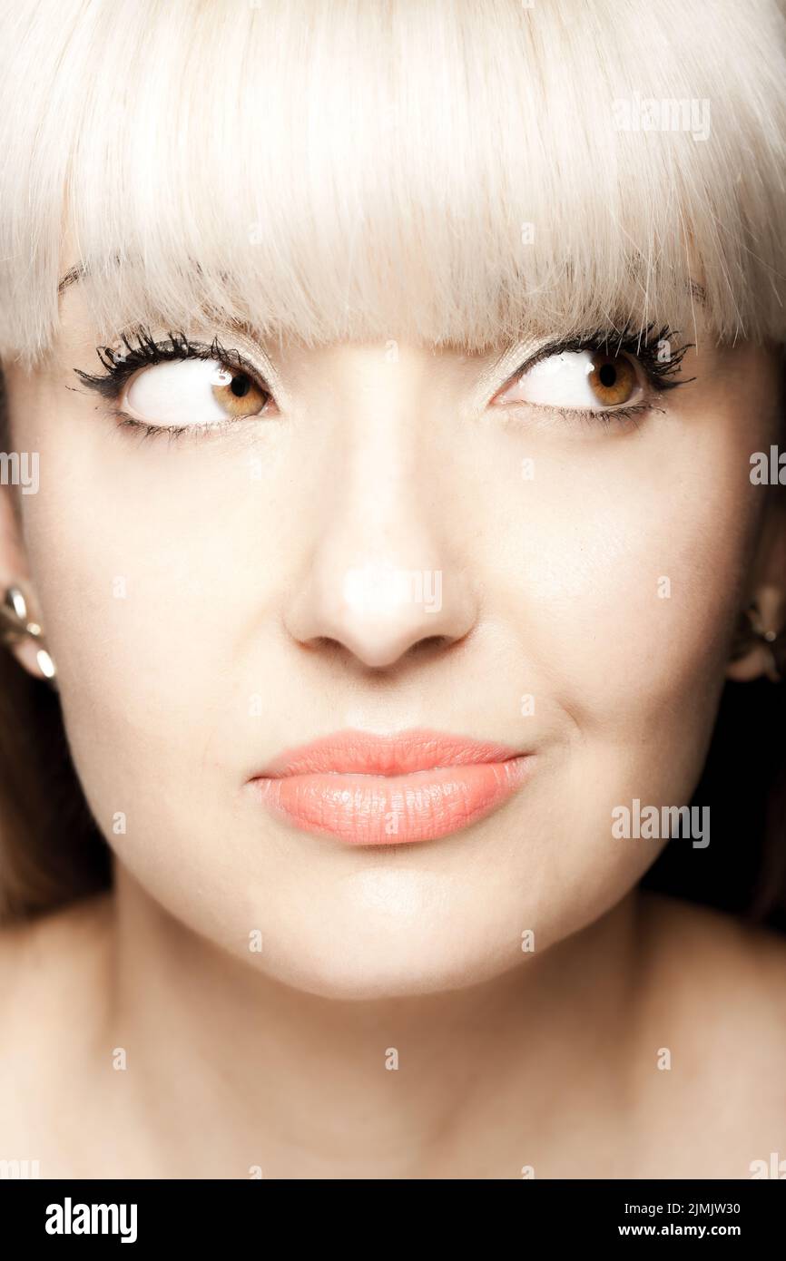 Close up portrait of a beautiful brunette girl with blond bangs fringe. Positive face expression Stock Photo