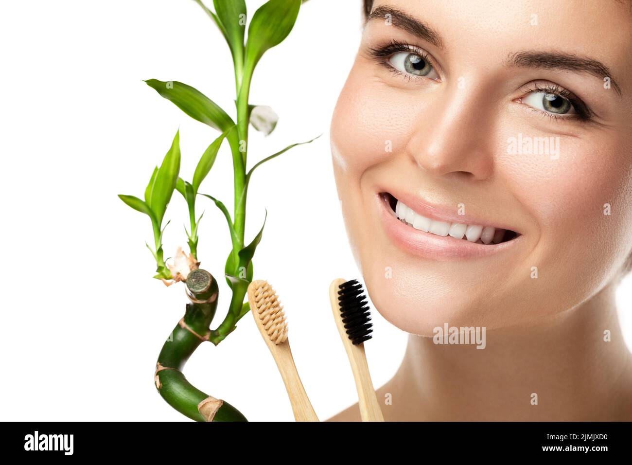 Young happy woman with eco-friendly bamboo toothbrushes Stock Photo