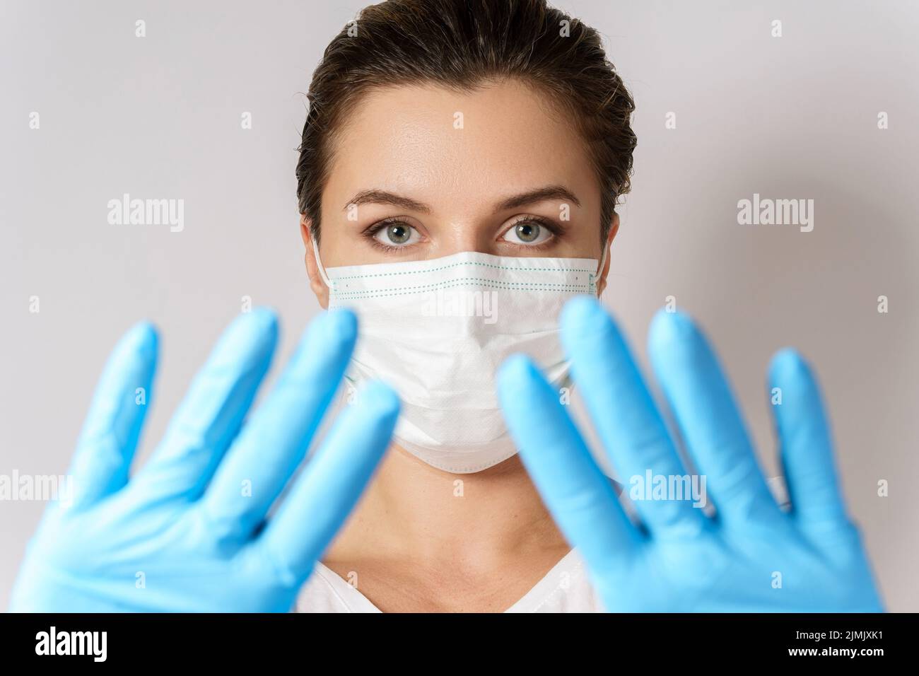 Woman is wearing a face mask and latex gloves for protection against ...