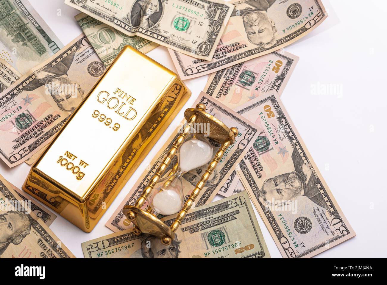 Gold bar, US dollar bills and hourglass Stock Photo Alamy