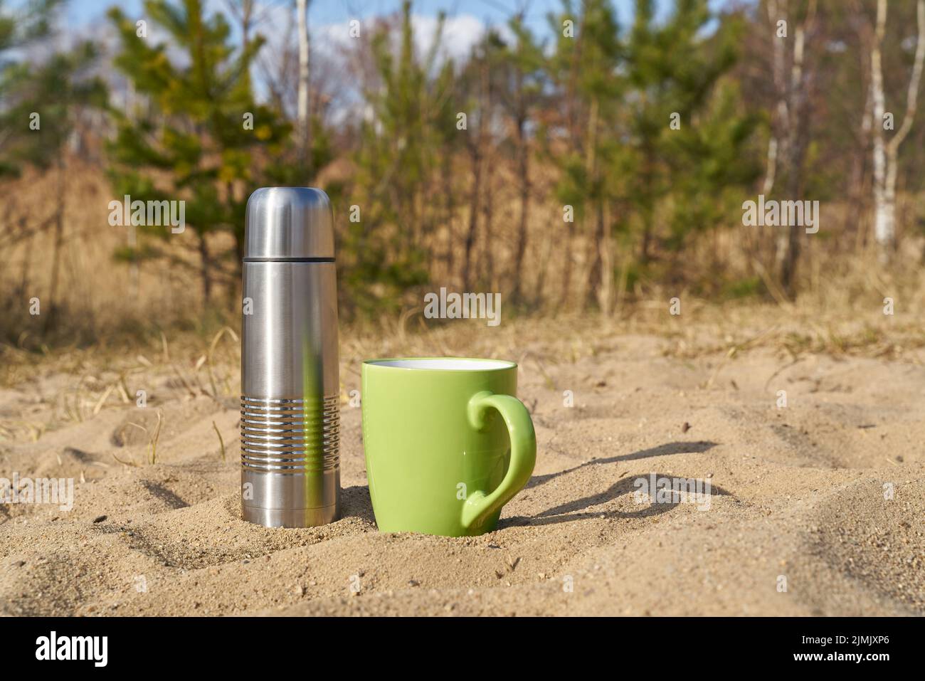 Picnic with thermos and cup on a spring day in nature Stock Photo