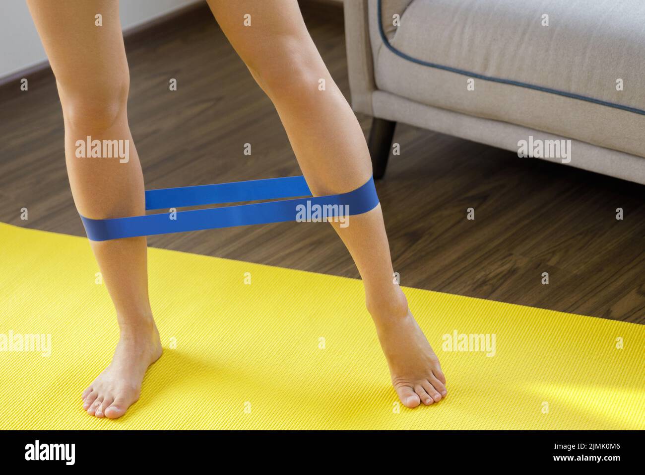 Free Photo  Girl stretching feet with a yellow resistance band on