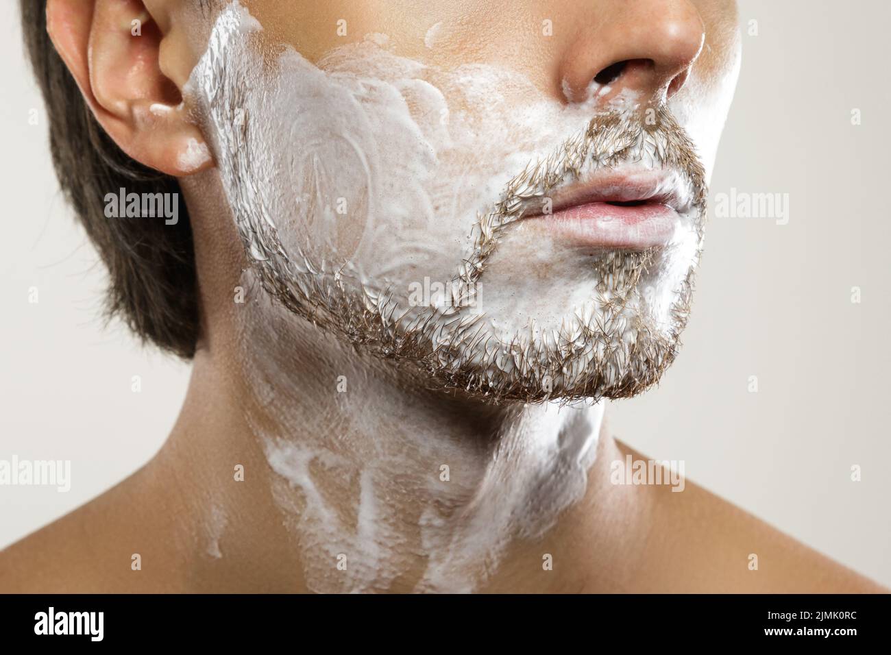Man with a shaving cream on his face Stock Photo Alamy