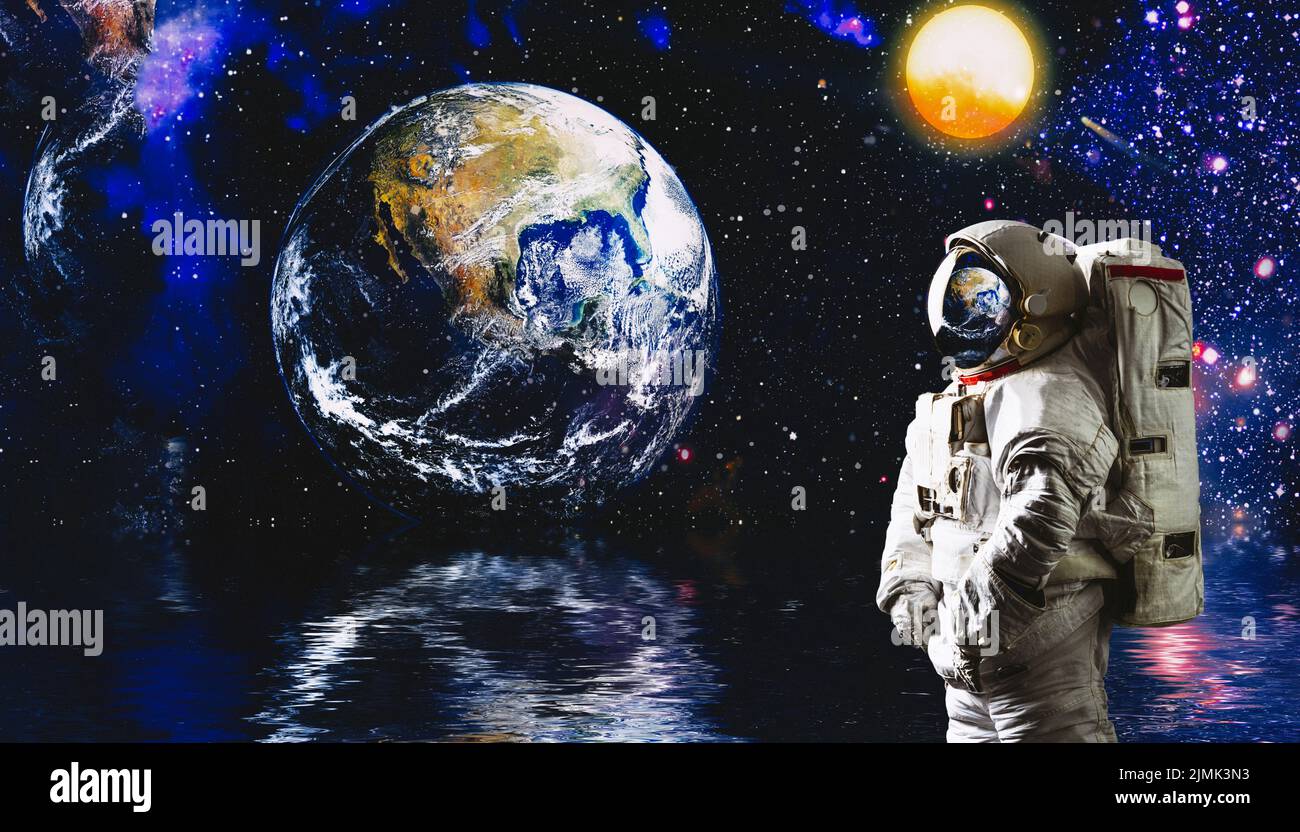 Astronaut in the space over the nightly planet Earth. Abstract wallpaper.  Spaceman. Elements of this image furnished by NASA Stock Photo