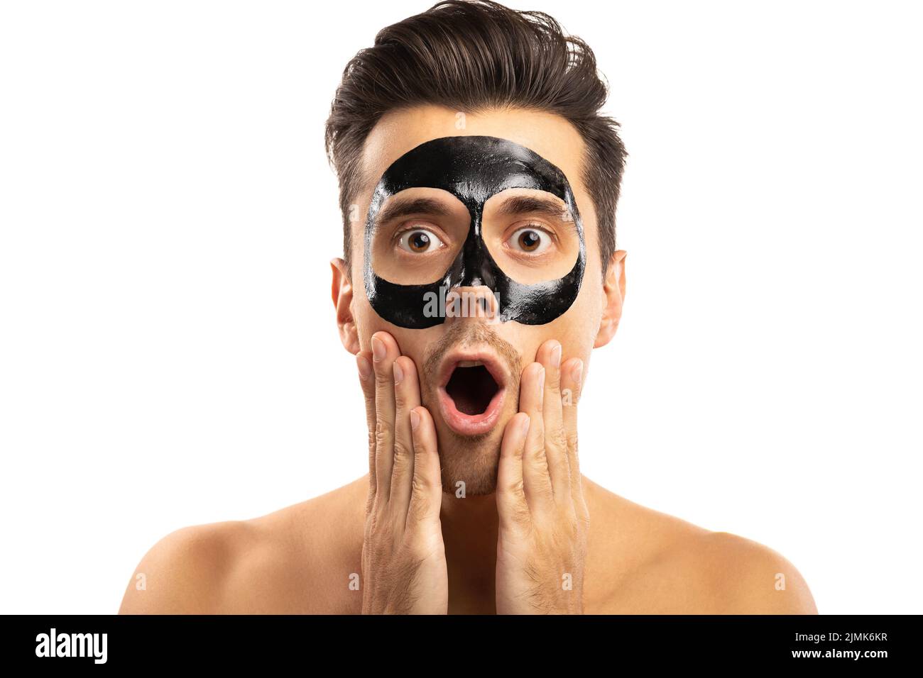 Young guy with a black charcoal mask on his face on white background