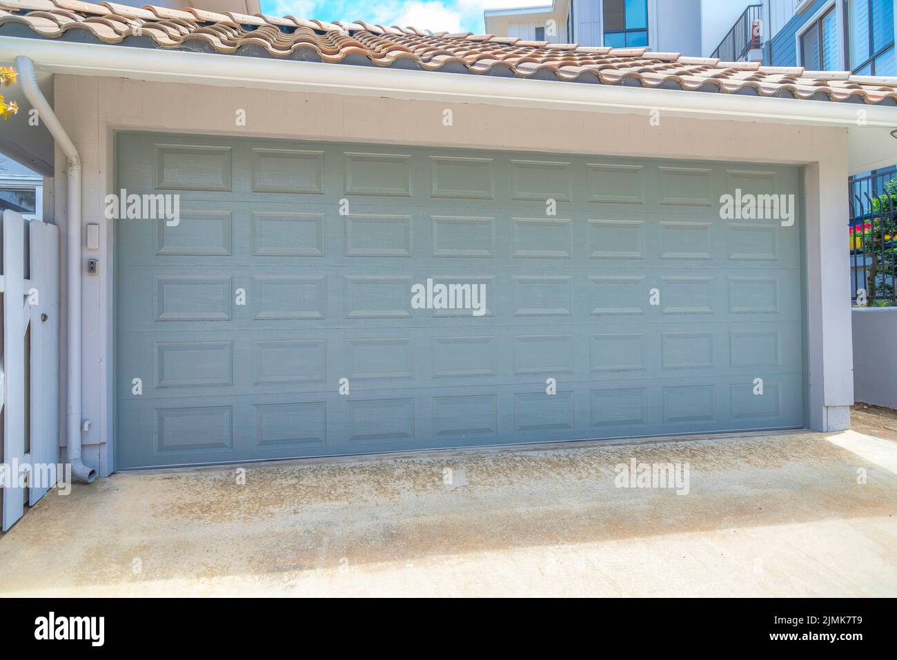 Garage exterior with light gray sectional door at La Jolla in San Diego