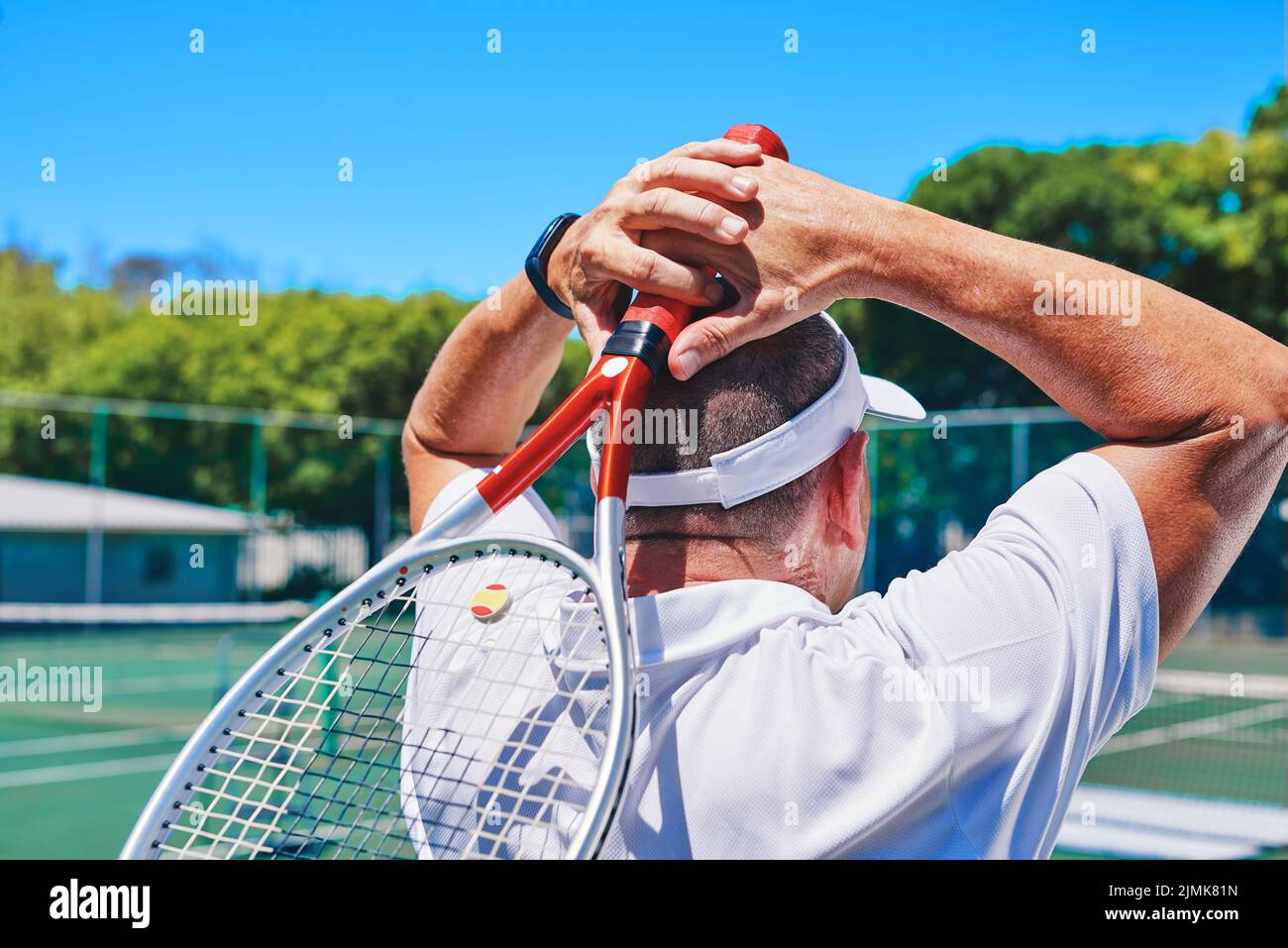 Taking a moment to catch my breath. an unrecognizable sportsman standing alone on the court during the day. Stock Photo