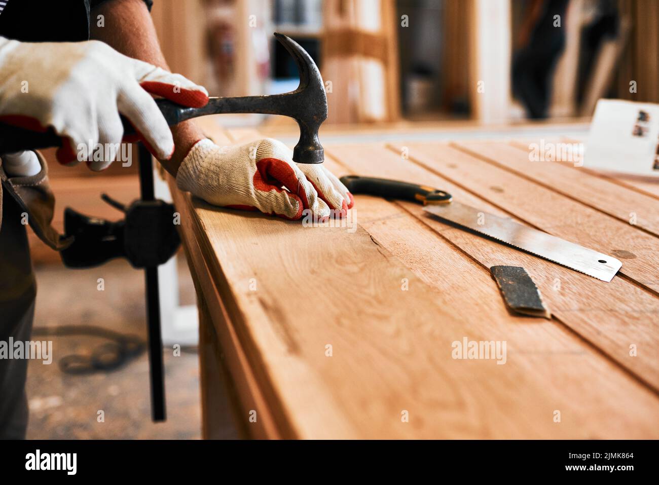 Its hammer time. an unrecognizable carpenter hammering nails on wood