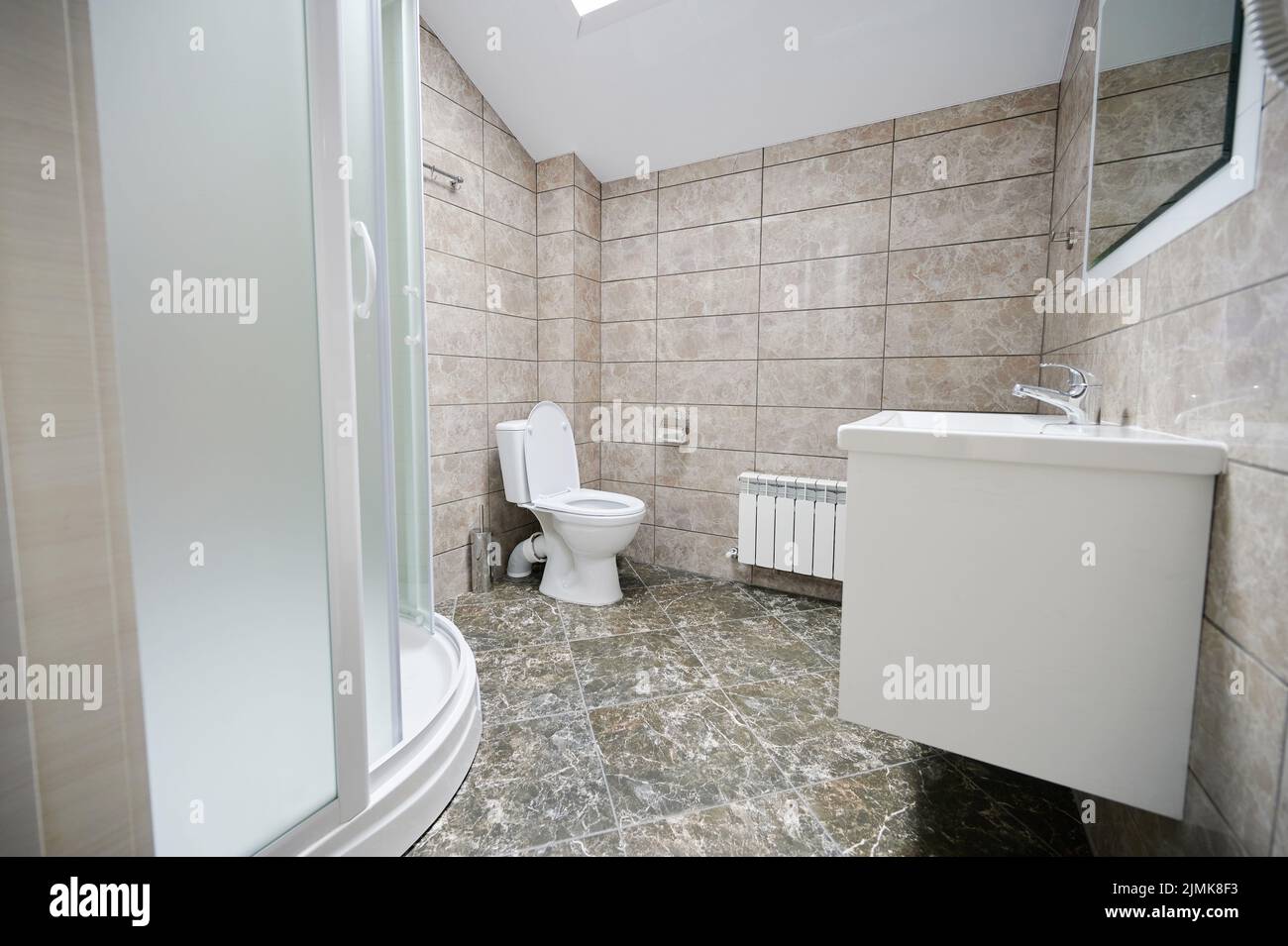Empty washroom side view with clean marble interior Stock Photo