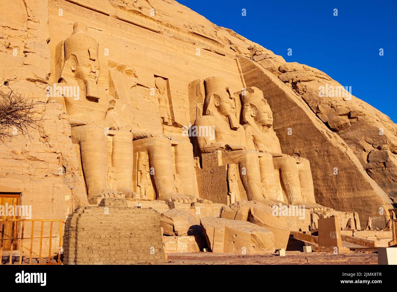 Seated statue of Ramses II in front of The Great Temple of Ramses II at Abu Simbel Village. Stock Photo