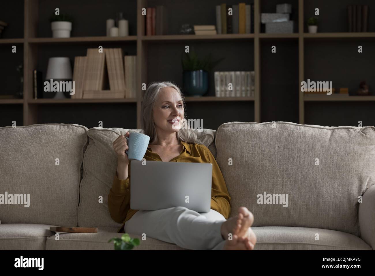 Older woman relaxing sofa hi-res stock photography and images - Alamy