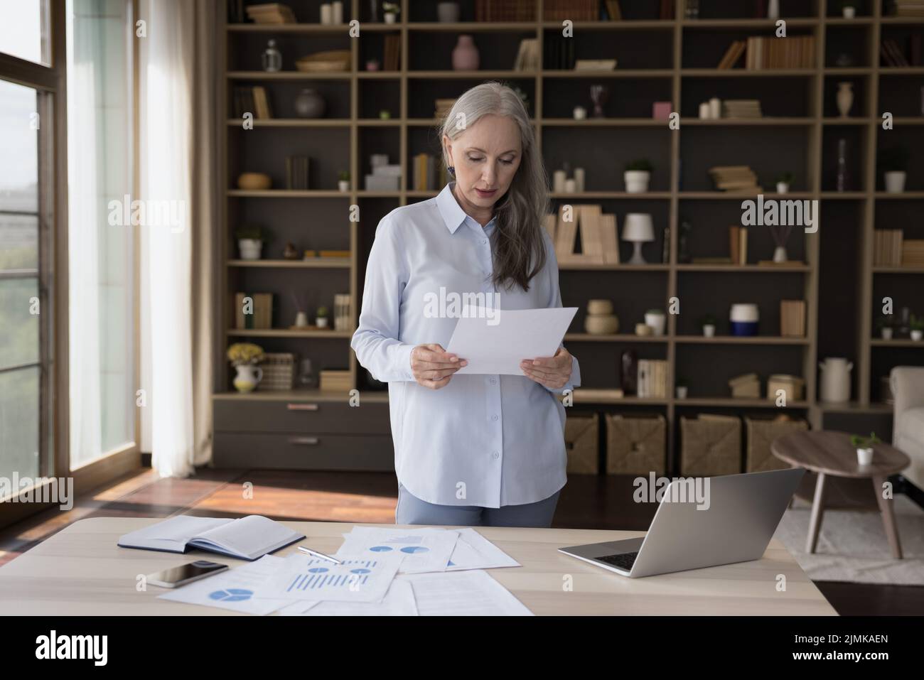 Woman paperwork home mature hi-res stock photography and images - Alamy