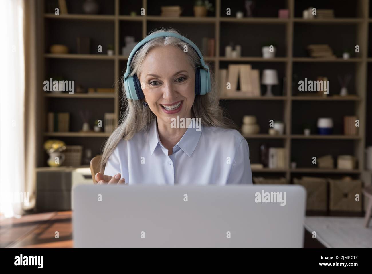 Happy pretty mature 60s woman talking on video call Stock Photo - Alamy