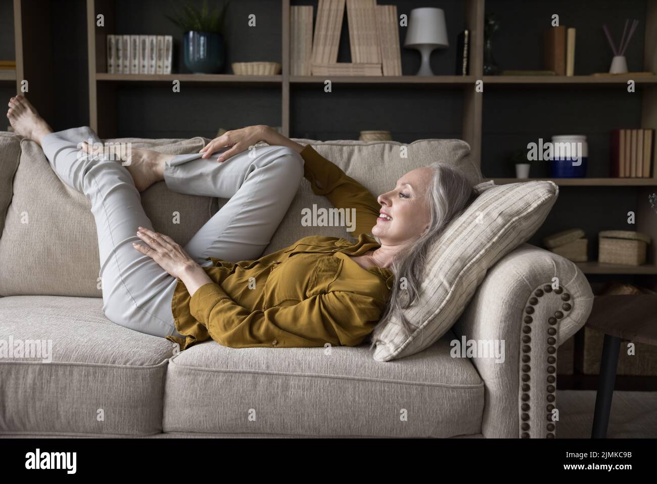 Mature woman lying on couch hi-res stock photography and images - Alamy