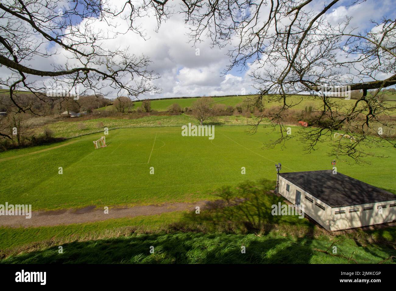 BAMPTON, DEVON, UK - APRIL 7, 2022 community football pitch with green agricultural fields in the West Country Stock Photo