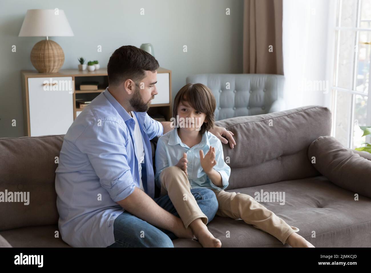 Loving dad listen with interest his little son Stock Photo
