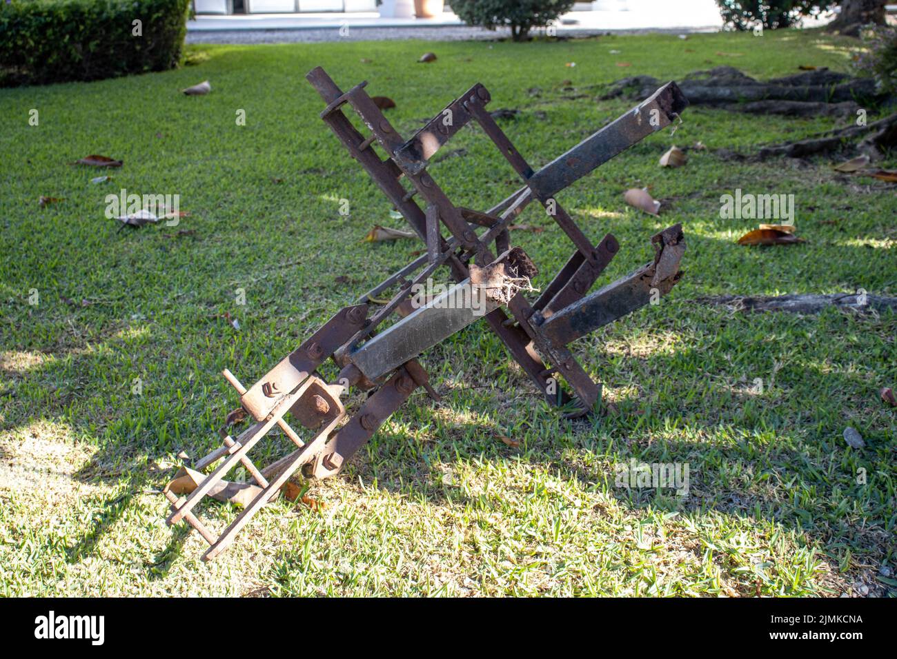 MARBELLA, ANDALUSIA, SPAIN - NOVEMBER 3, 2021 old farm plough on a grass lawn Stock Photo