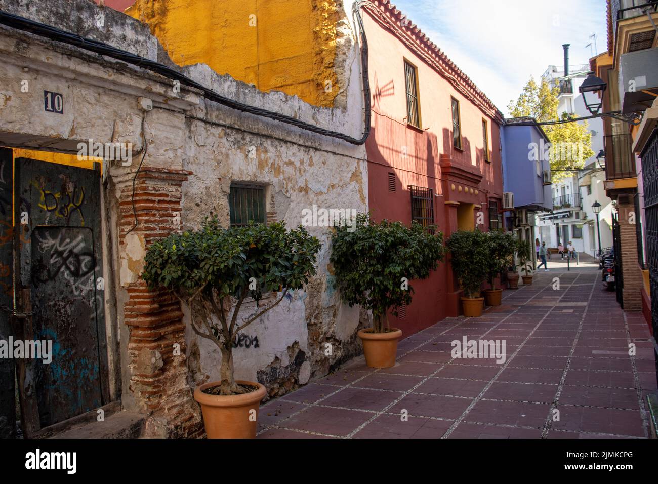 MARBELLA, ANDALUSIA, SPAIN - NOVEMBER 3, 2021 old house and wall with potted trees in the old town Stock Photo