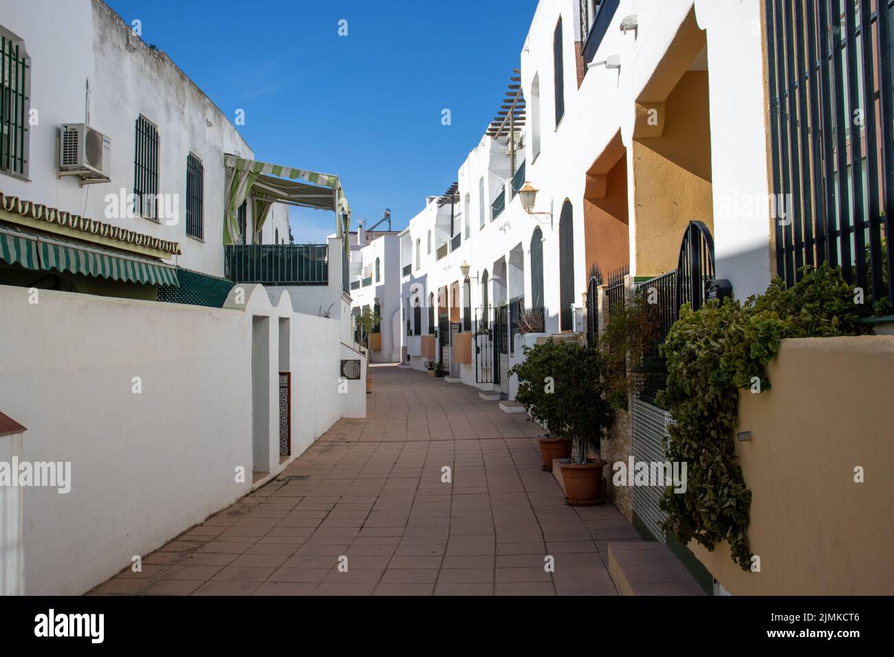 MARBELLA, ANDALUSIA, SPAIN - NOVEMBER 3, 2021 quiet urbanisation of paved pavements, white walls and sunshine Stock Photo
