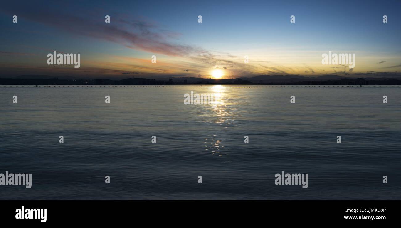 Tranquil seascape with sunset sky Stock Photo