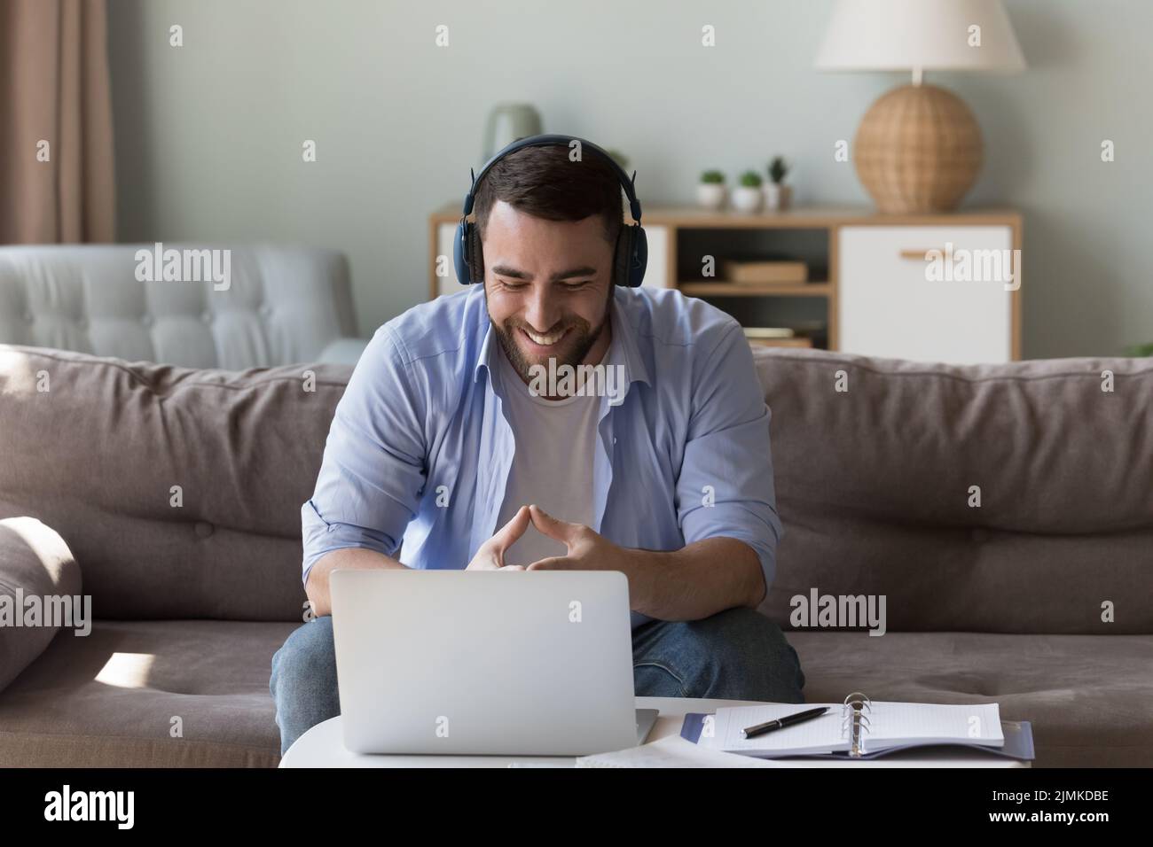 Smiling man take part in video call at home Stock Photo