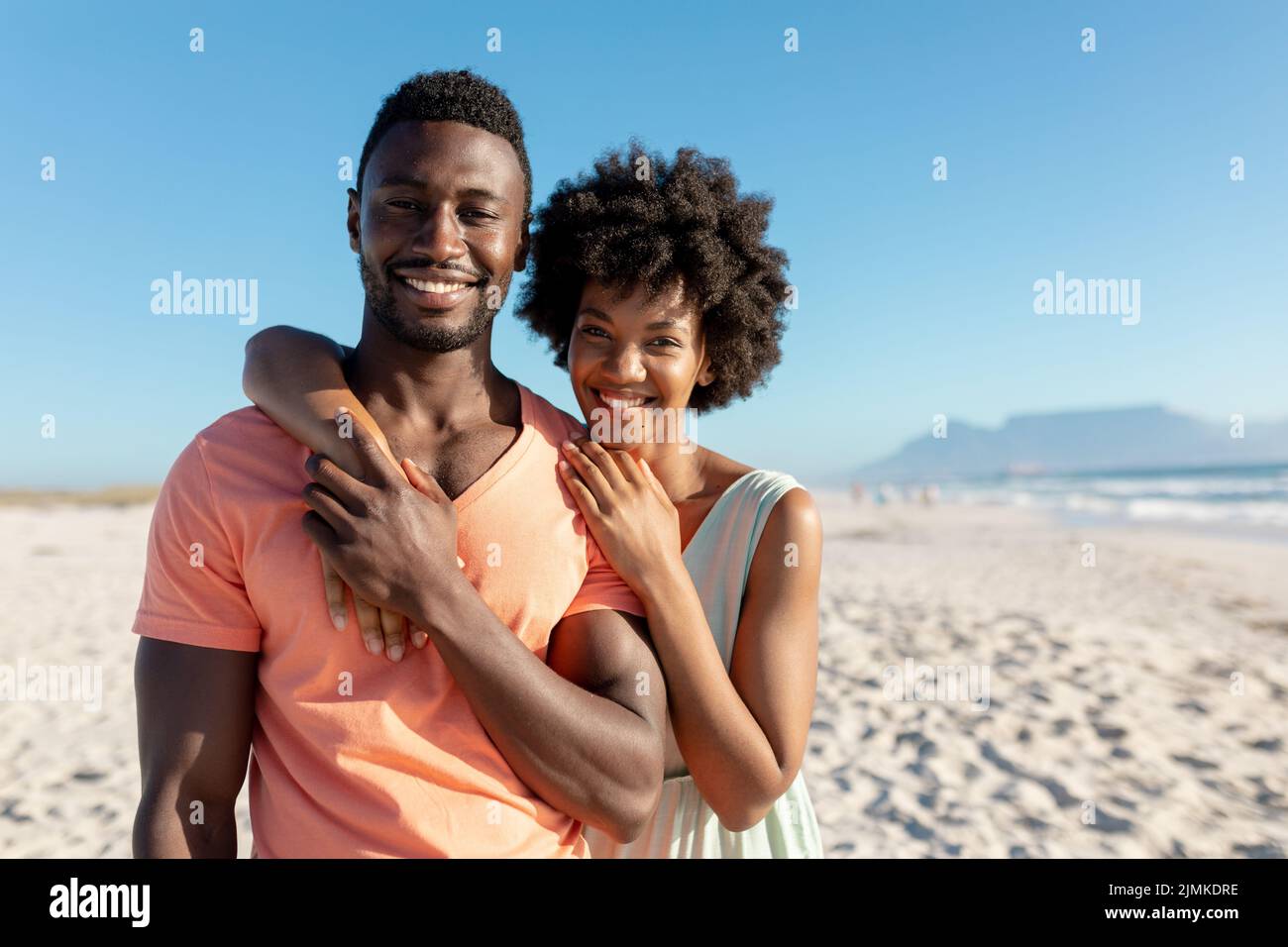 Portrait of smiling african american woman embracing boyfriend from ...