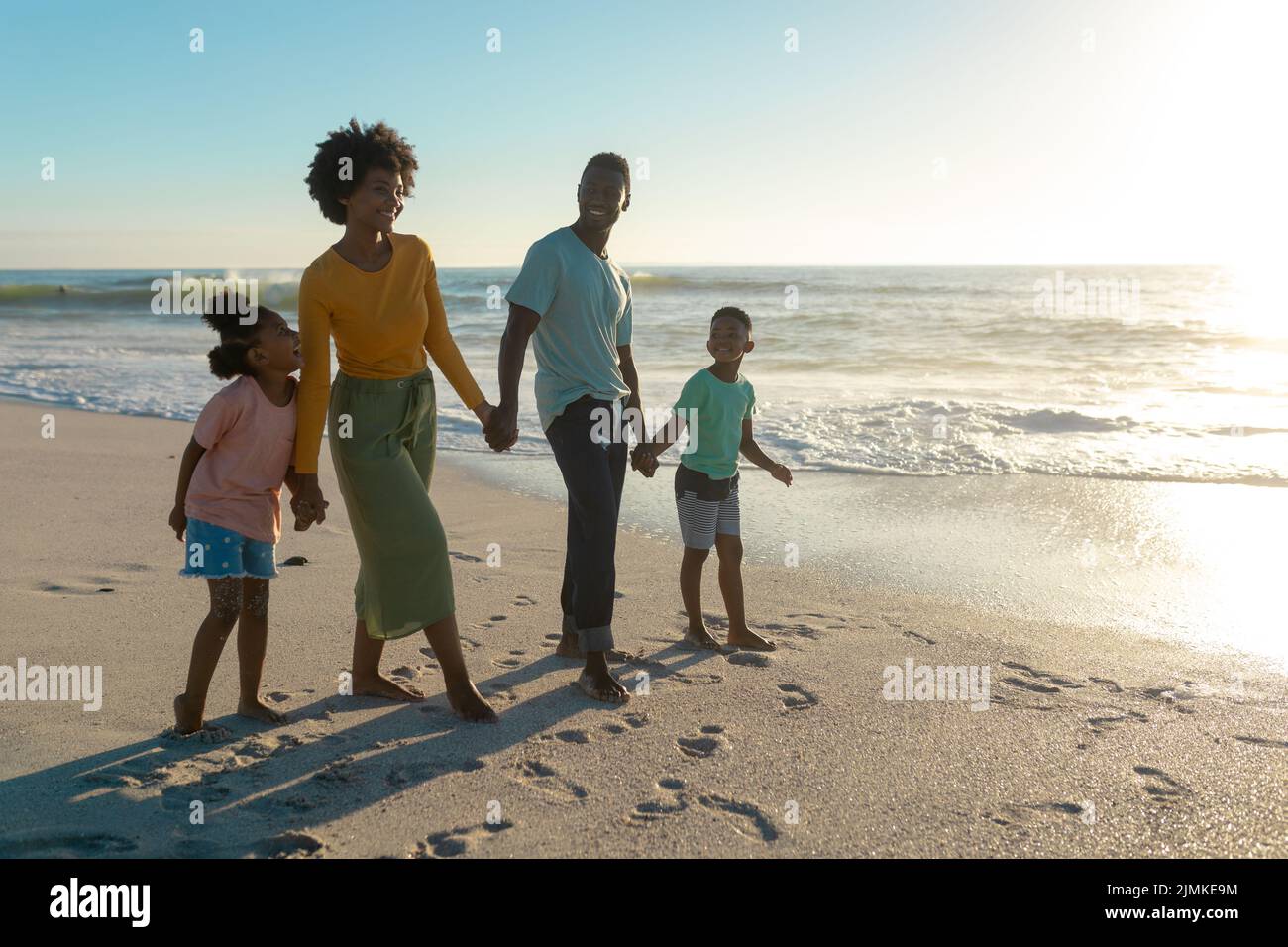 Full length of happy african american family enjoying summer holiday