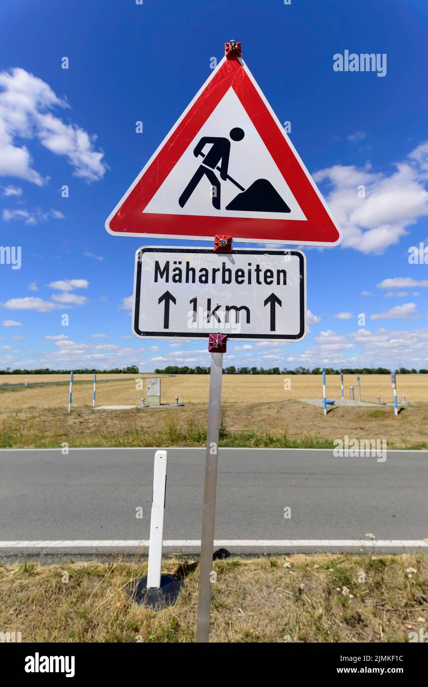 Traffic sign Caution Construction Work with additional sign Mowing Work in German language Stock Photo