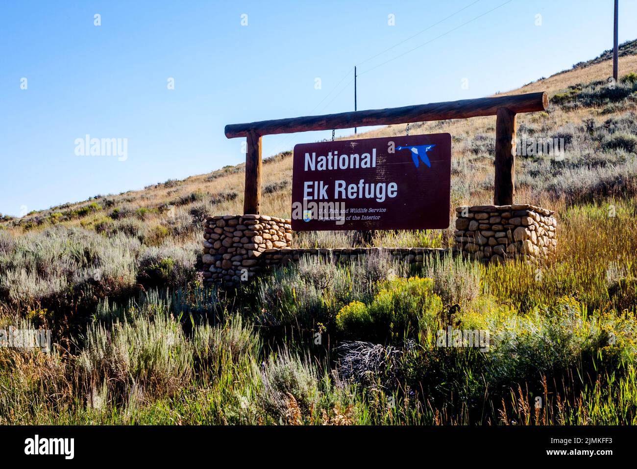 National Elk Refuge hanging sign and stone structure in Grand Teton National Park. Stock Photo