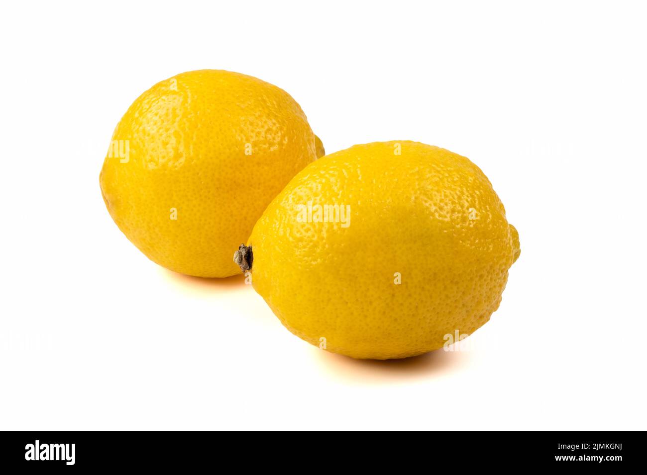 Two fresh lemons isolated on bright background. Close up view. Stock Photo