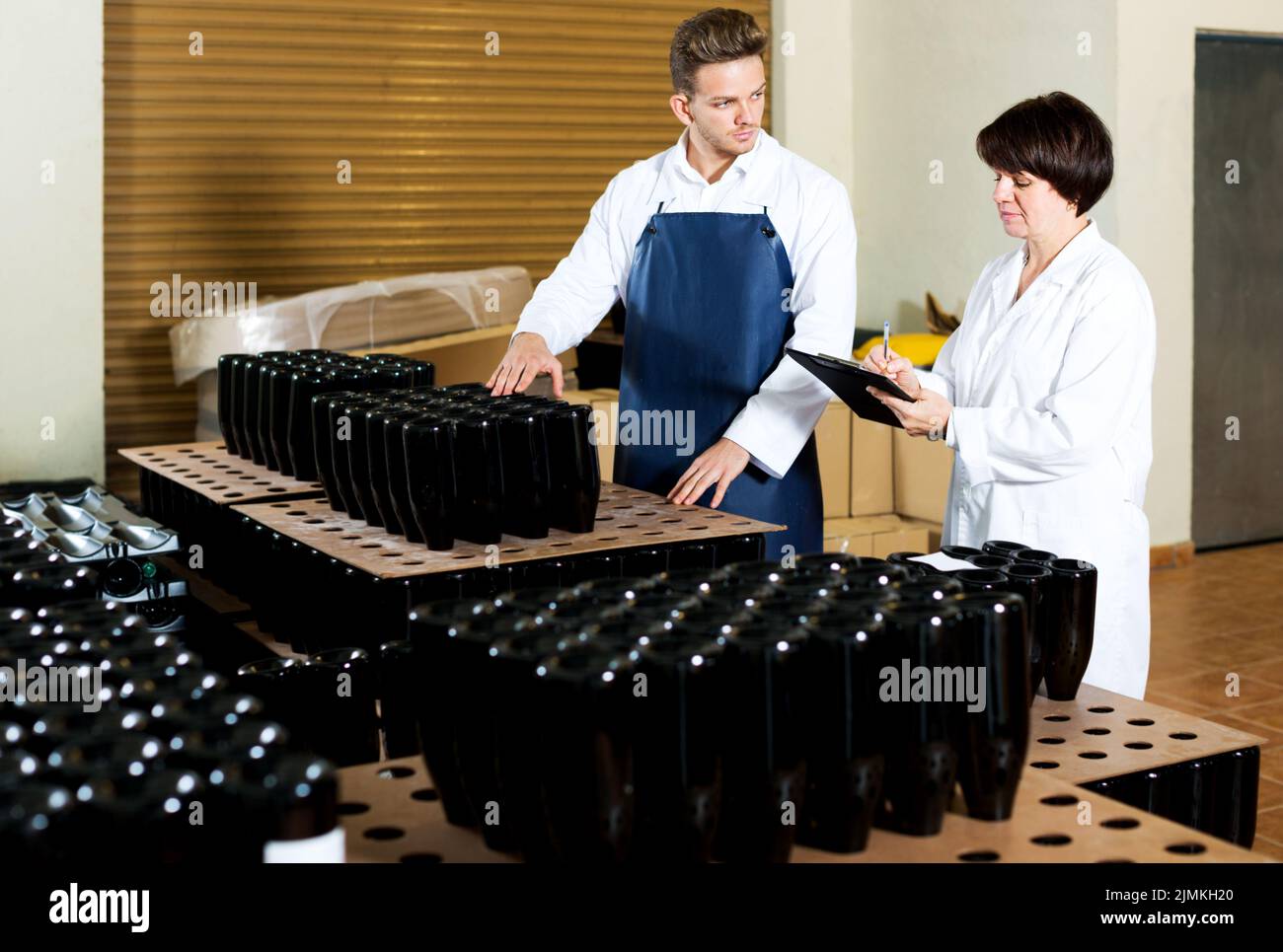 Employees checking number of wine bottles Stock Photo