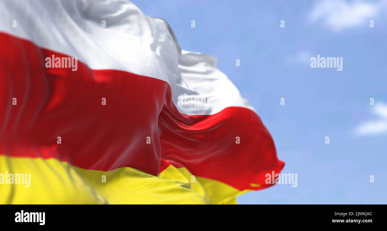 Detail of the national flag of South Ossetia waving in the wind on a clear day. Stock Photo