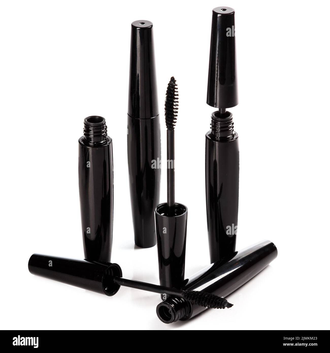 Black mascara brushes and containers on white background Stock Photo