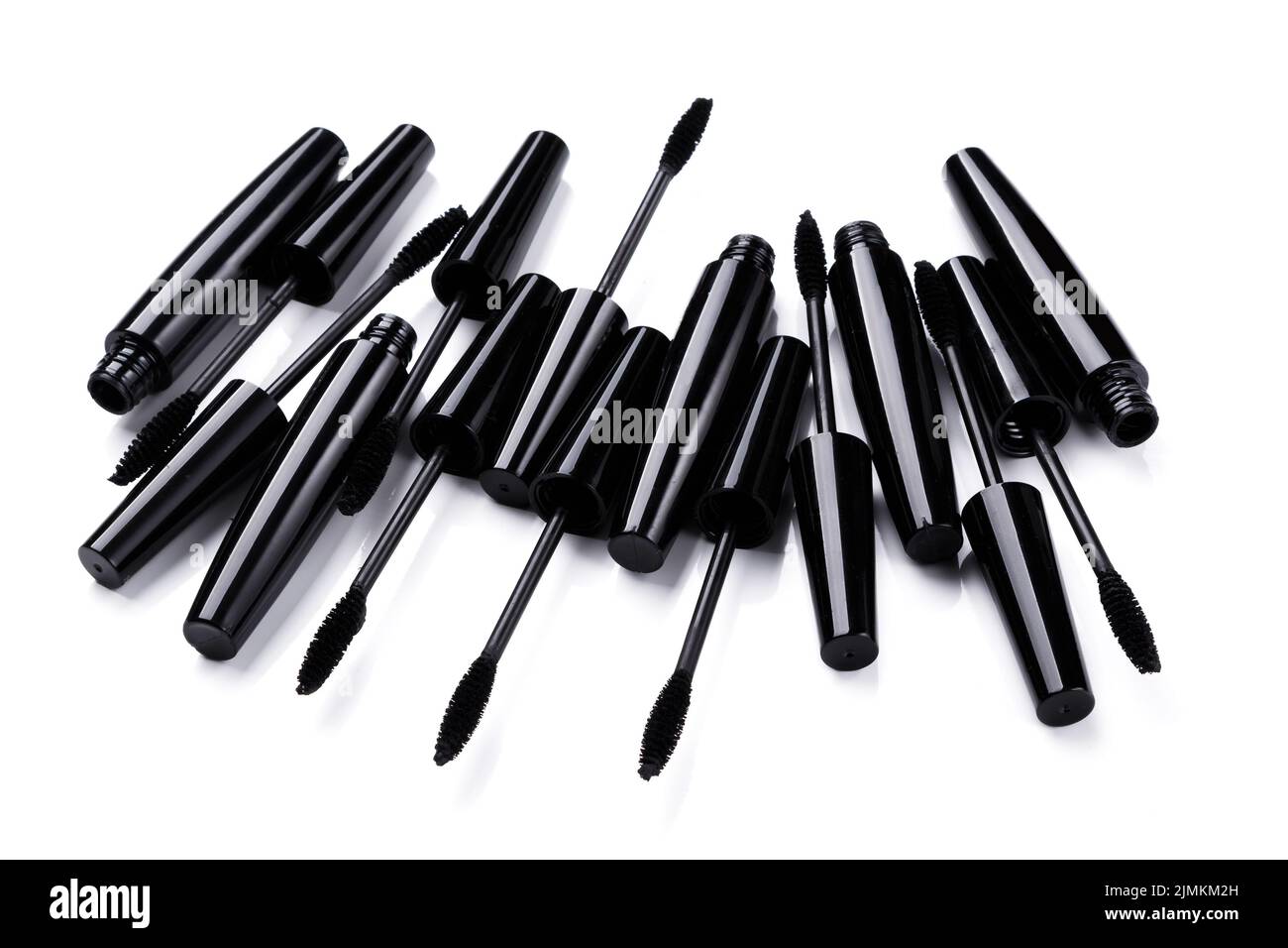 Black mascara brushes and containers on white background Stock Photo